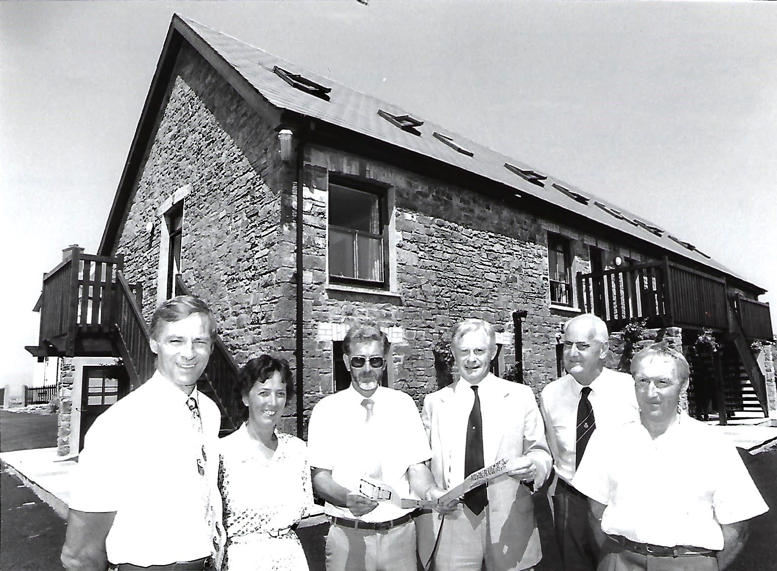 Black and white photograph showing Helen and Eric Mock and the official opening of the Coach House